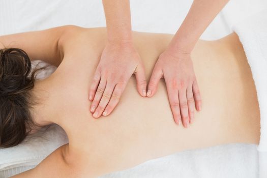 Close up of a beautiful woman enjoying back massage at beauty spa