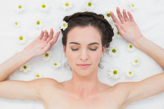 Overhead view of a beautiful young woman with flowers in beauty salon