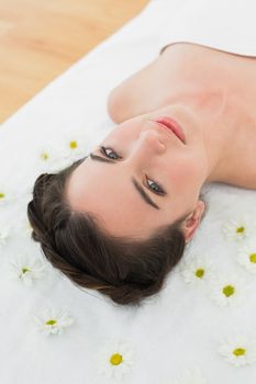 Close up portrait of a beautiful young woman with flowers in beauty salon