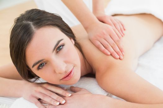 Close up of a beautiful woman enjoying back massage at beauty spa