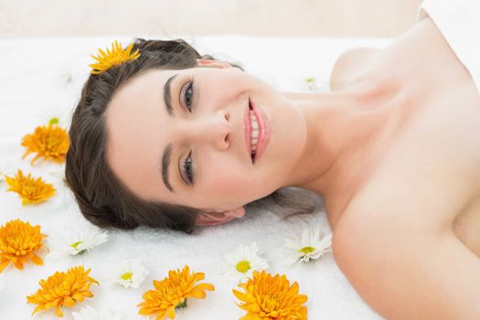Close up portrait of a beautiful young woman with flowers in beauty salon