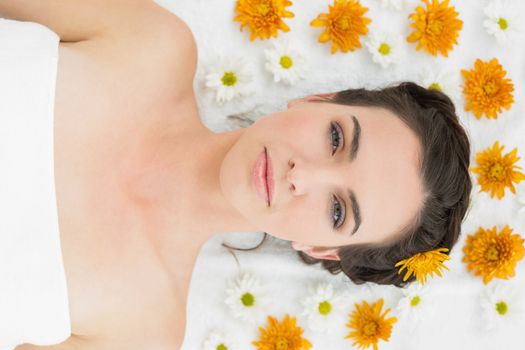 Close up portrait of a beautiful young woman with flowers in beauty salon