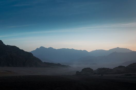 night desert landscape with rocky mountains and sunset sky with clouds in Sharm El Sheikh Egypt