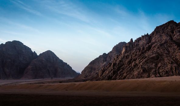 night desert landscape with rocky mountains and sunset sky with clouds in Sharm El Sheikh Egypt