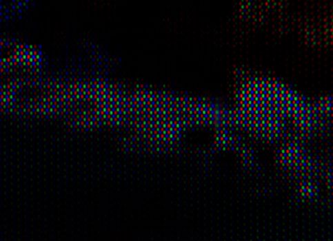 abstract background pattern of colored blurry dots on a dark background close up