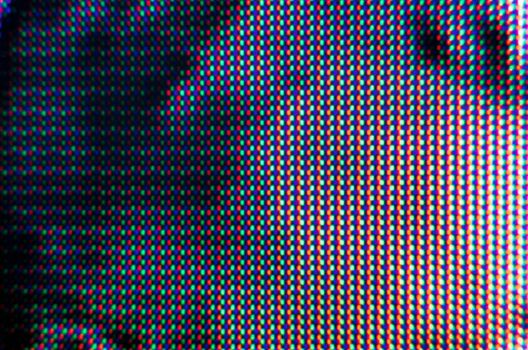 abstract background pattern of colored blurry dots on a dark background close up