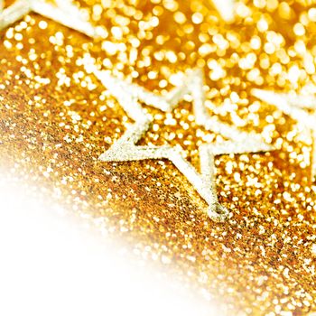 Christmas decorative stars on shiny glitters golden background