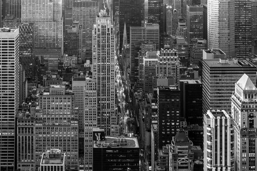 Aerial view of New York City skyline with 5th Avenue at Manhattan midtown. Urban skyscrapers at dramatic after the storm sunset, USA. Black and white image.