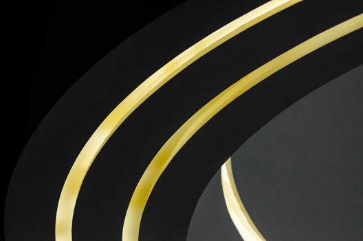 part of a modern building with lighting abstract background shades of gray and yellow curved lines