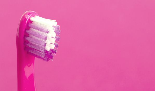 Dental care toothbrush isolated on pink background