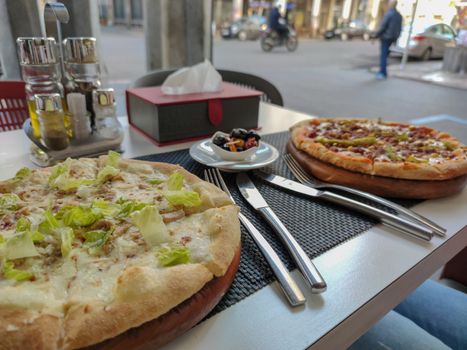 Delicious pizza on a table outside a restaurant