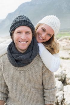 Portrait of a happy romantic young couple standing together on a rocky landscape