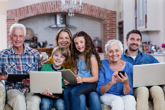 Multi-generation family using a laptop, tablet and phone at home