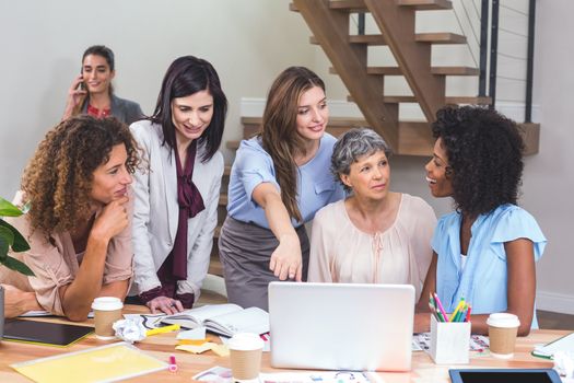 Group of interior designers interacting with each other in office