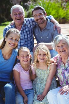 Portrait of happy family sitting in back yard