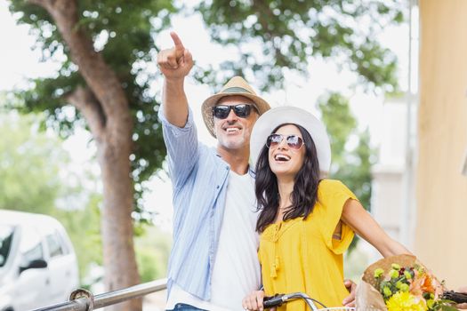 Man pointing with woman standing outdoors