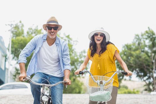 Portrait of happy couple cycling outdoors