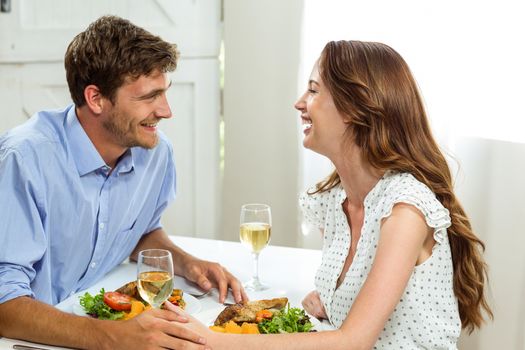 Happy romantic couple having lunch at home