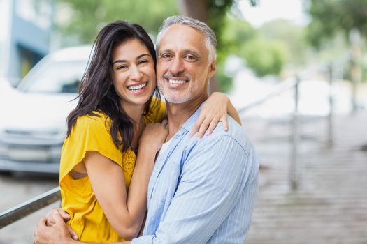 Portrait of happy couple hugging outdoors