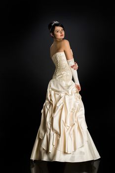 Young beautiful woman in a wedding dress on a studio background