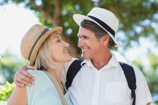 Happy couple looking face to face while standing outdoors