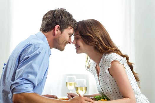 Romantic couple holding wineglasses at home