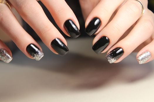 Evening manicure design in black and gold color