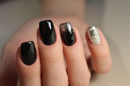 Evening manicure design in black and gold color