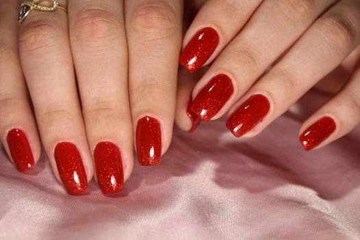 beautiful female hands with sexy red manicure.