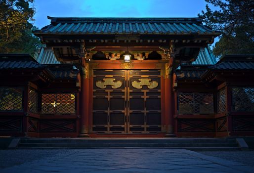 Beautiful gate nammed karamon "唐門" of the entrance of the Shintoist Nezu shrine of the 18th century in Tokyo with its lanterns in the night.