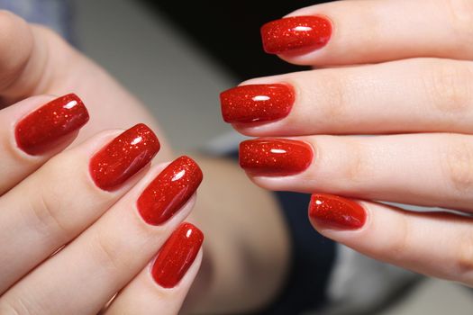 Bright red manicure design with gel varnish