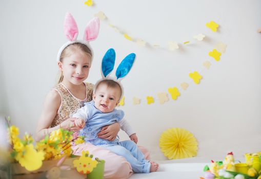 Cute little children boy and girl wearing bunny ears in Easter
