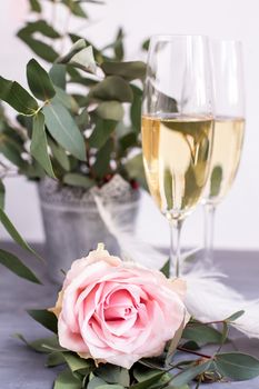 Composition with glasses of vine and flowers on grey concrete background