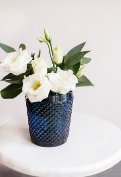 White flowers in classic blue glass. Lisianthus. Eustoma.