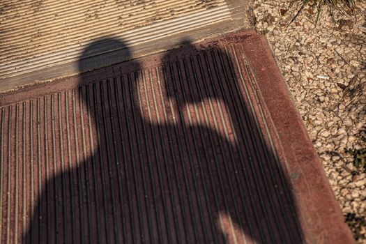 Shadow of the photographer on the street