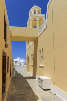 Street next to a church in Oia,Santorini by beautiful day, Greece