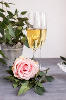 Composition with glasses of vine and flowers on grey concrete background