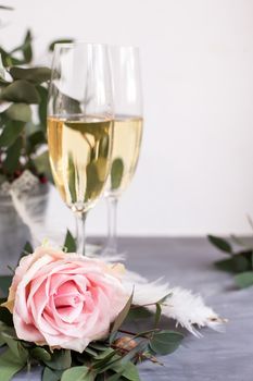 Composition with glasses of vine and flowers on grey concrete background