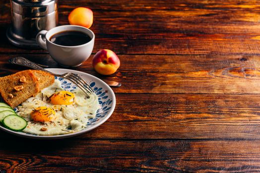 Breakfast toast with fried eggs with vegetables on plate and cup of coffee with fruits over dark wooden background. Healthy, clean eating, dieting food concept.