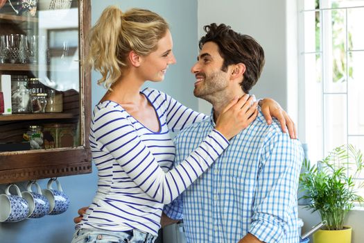 Romantic couple embracing each other in kitchen