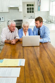 Agent talking to senior couple while sitting at table