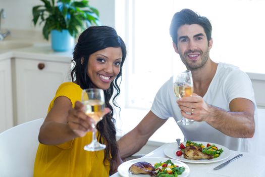 Romantic couple looking at each other and smiling at home