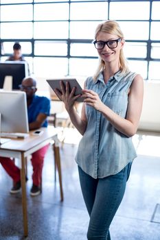 Portrait of Young woman holding digital tablet in the office