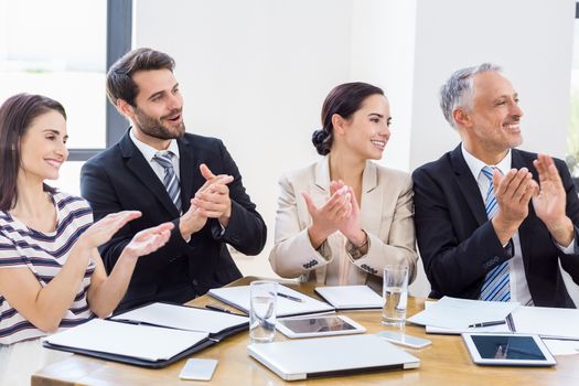 Workers are applauding and smiling at work