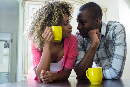 Romantic couple having coffee together at home