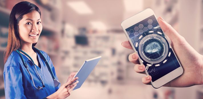 Asian nurse using tablet against medical interface in blue and black