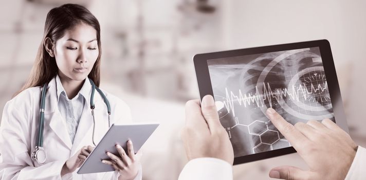 Asian doctor using tablet against pretty science student smiling at camera