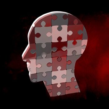 Head made of jigsaw pieces against dark background