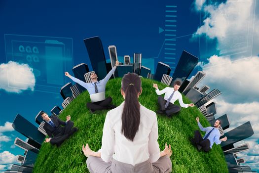 Businesswoman sitting in lotus pose against scenic view of blue sky