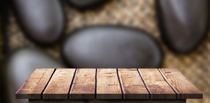 Wooden Floor against a pile of black stones